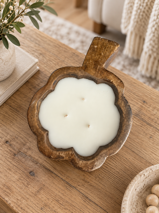 Wooden dough bowl filled with candle